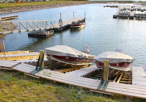 Rental boats resting in their slips on the lake at Eastbay Campground.