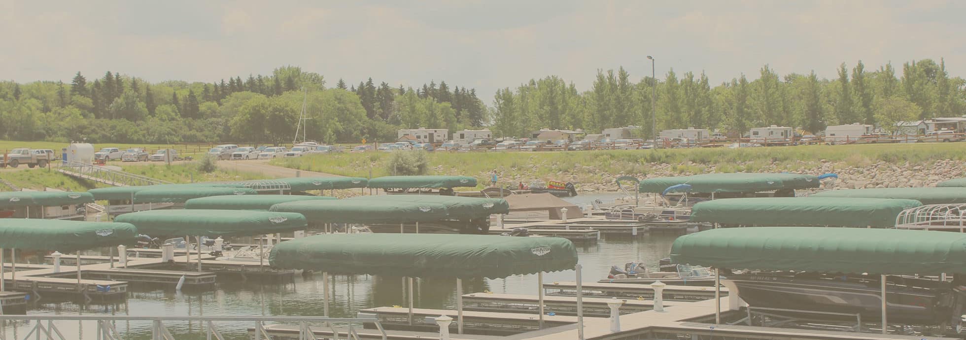 A view of the Eastbay Campground boat dock and marina with many covered slips available for boats.